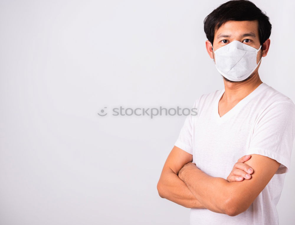 Similar – Man with facial mask and sunglasses looking at camera