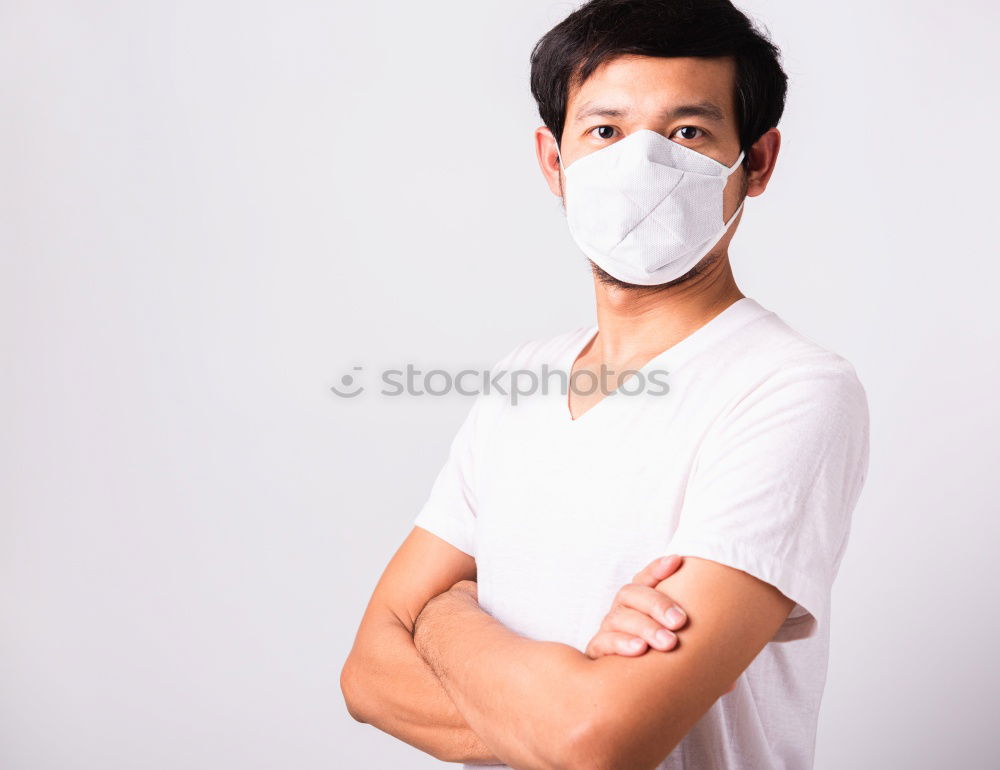 Similar – Man with facial mask and sunglasses looking at camera