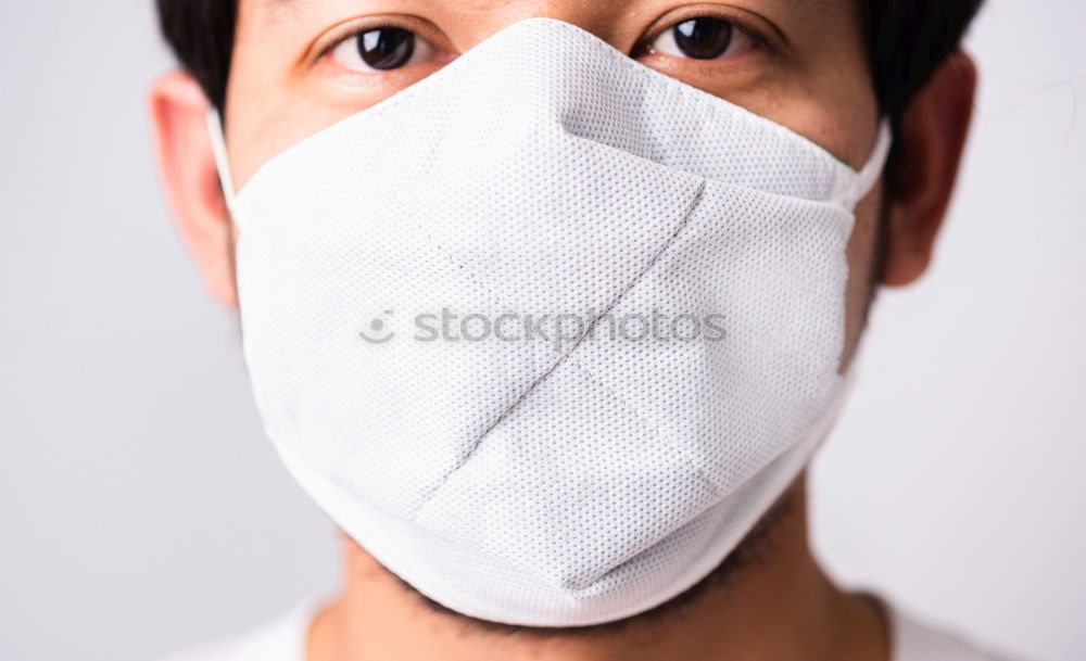 Similar – Man with facial mask and sunglasses looking at camera