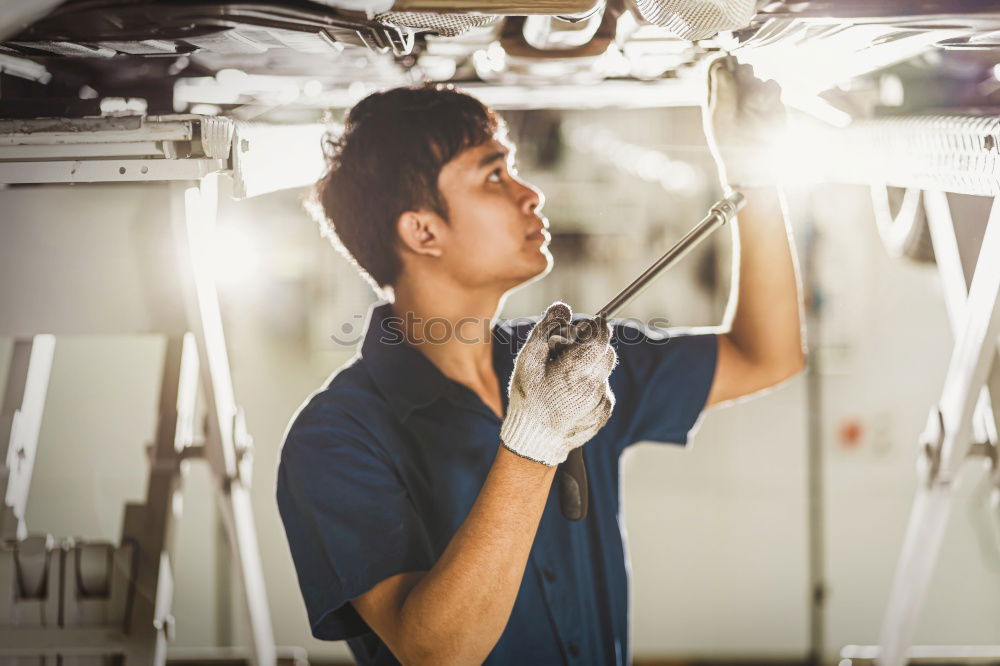 Similar – Professional Mechanic Repairing Car.