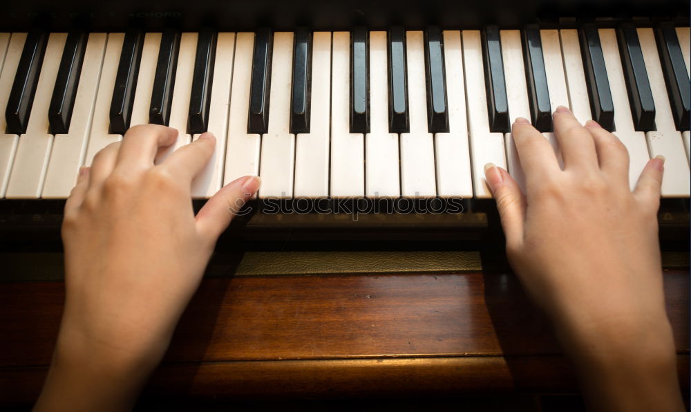 Similar – Toddler plays piano with delicate hands