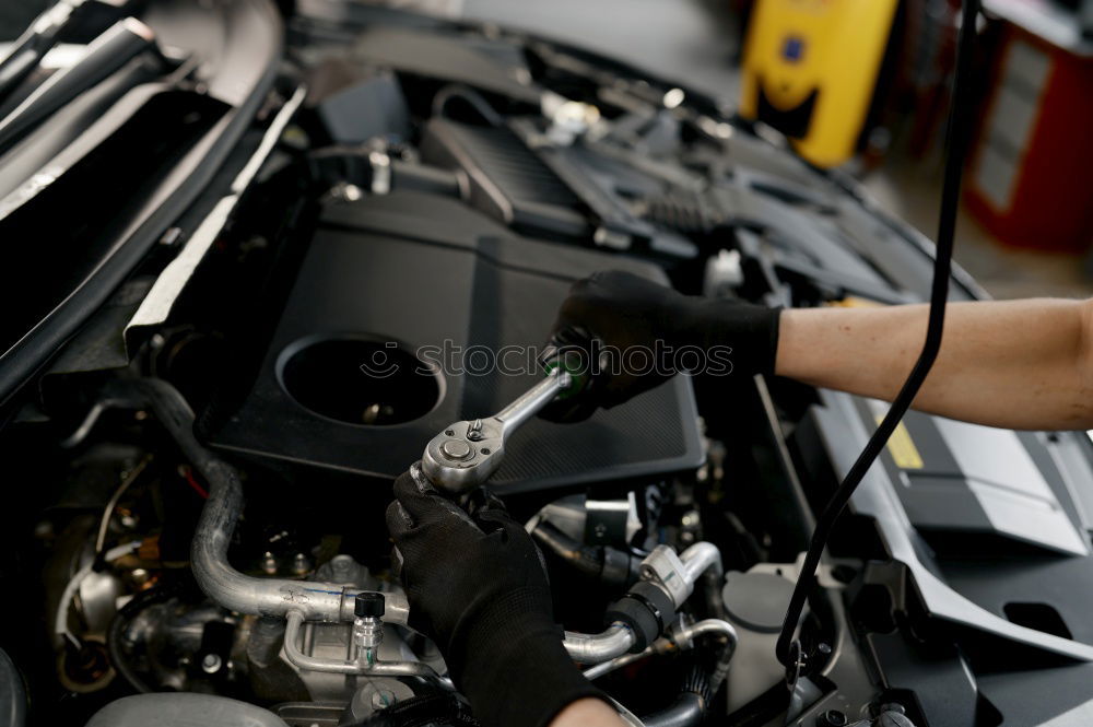 Similar – Professional Mechanic Repairing Car.