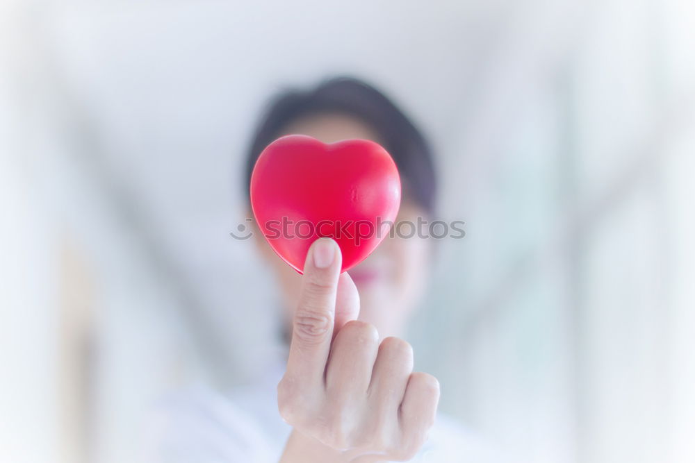 Woman’s foot with a red heart painted