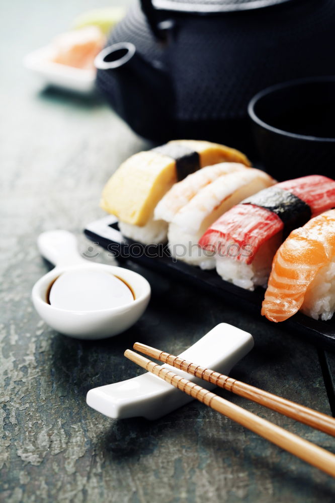 Similar – Female chef cutting japanese sushi roll