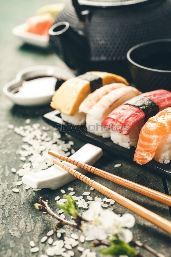 Similar – Female chef cutting japanese sushi roll