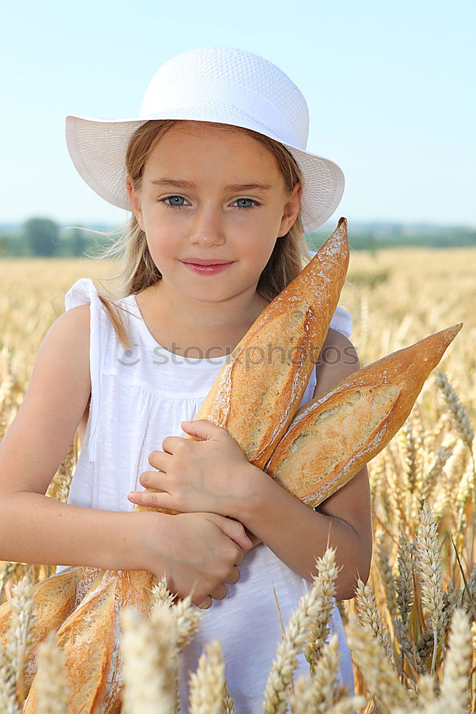 Similar – Image, Stock Photo smiling little girl holding wheat in hands