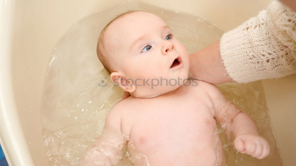 Similar – Bathing newborn baby girl.