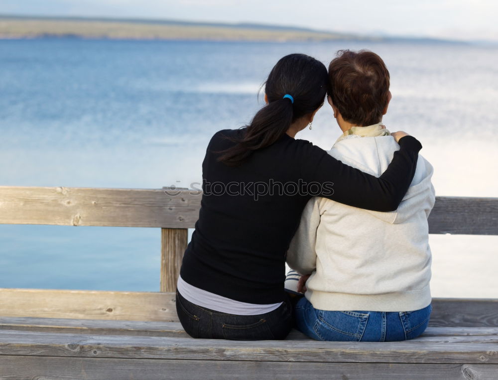 Similar – Brothers sitting at waterfront.Back view