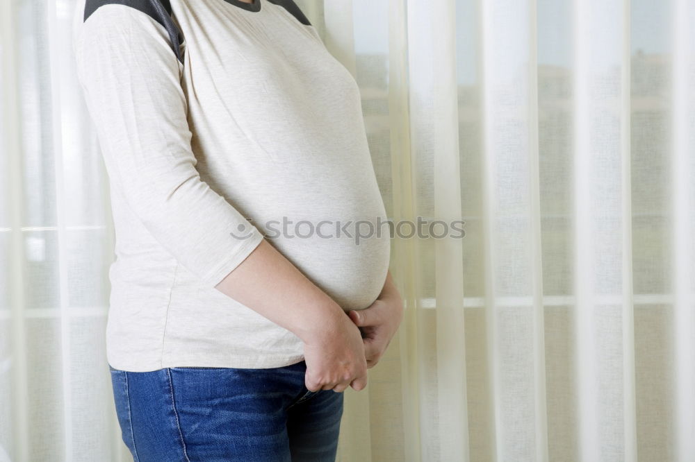 Similar – Who am I? Young woman holding a round mirror in front of her body. The mirror is showing her blurred face.