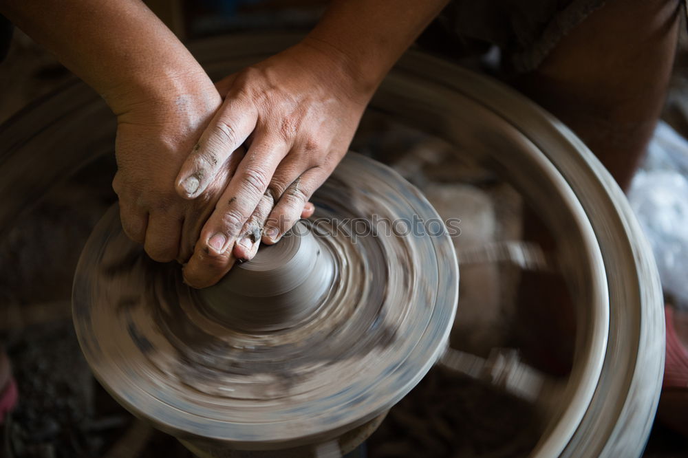 Similar – Hands of woodcarver make wooden bowl