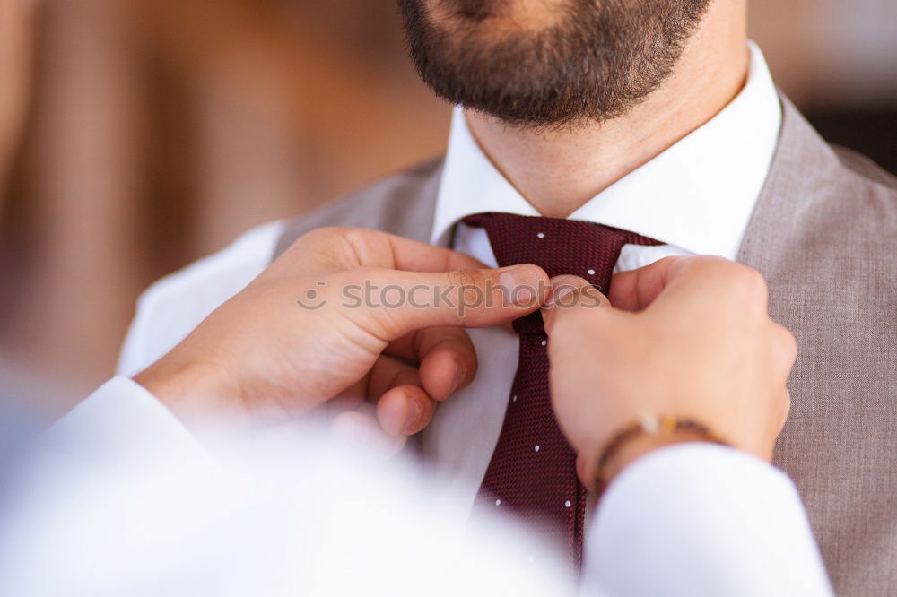 Similar – Image, Stock Photo Woman buttoning up man waistcoat