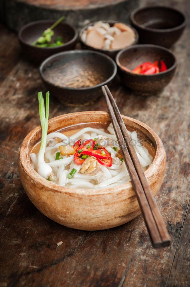 Geometric bowl of Asian Noodle Soup with chopsticks