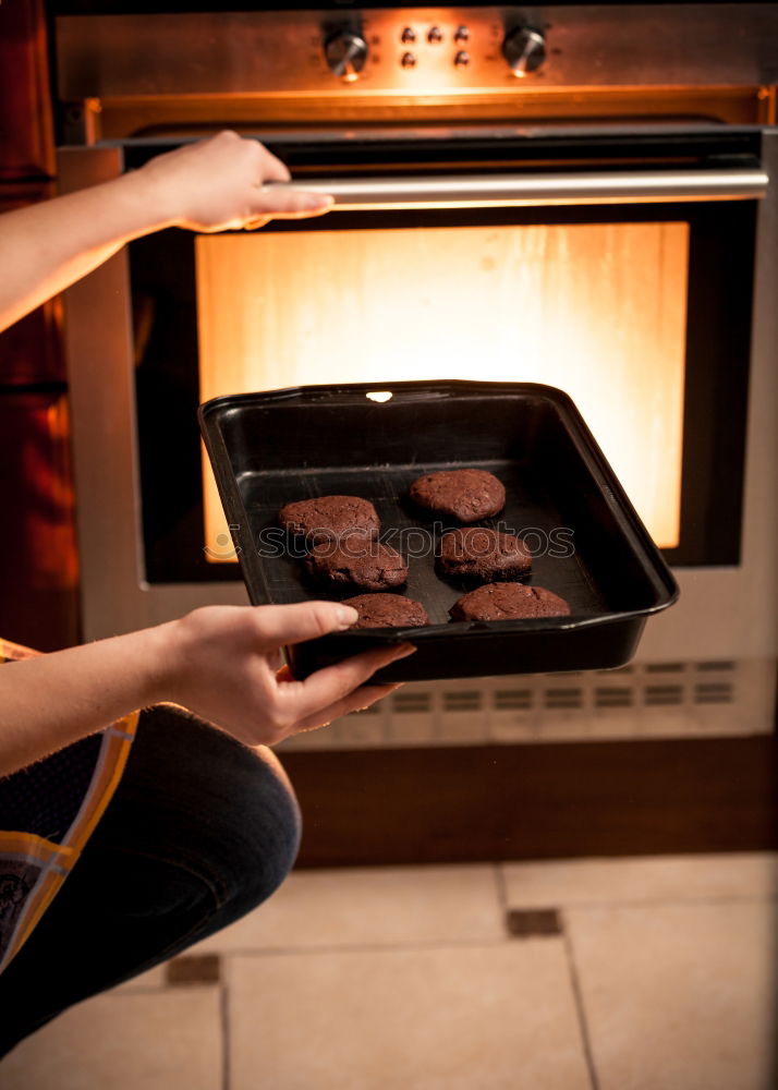 Man putting steaks into oven