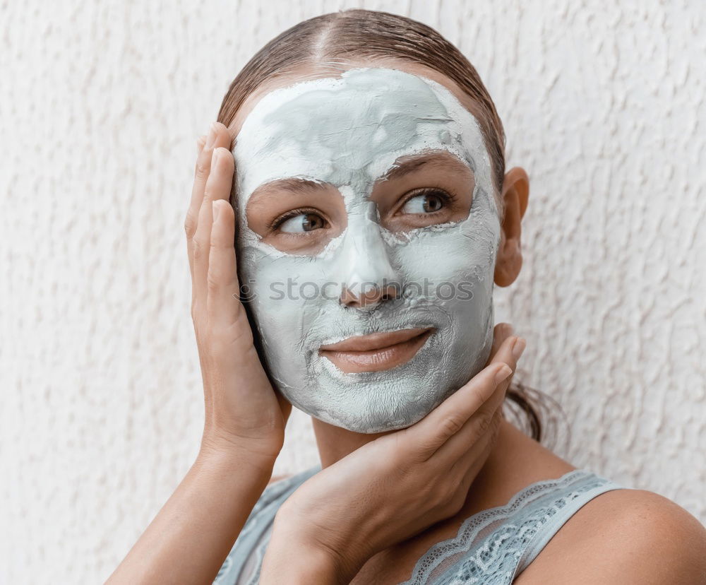 Similar – Image, Stock Photo Woman with bathrobe and towel on her head enjoys a face mask and holds two slices of cucumber in front of her eyes. Wellness, face care.