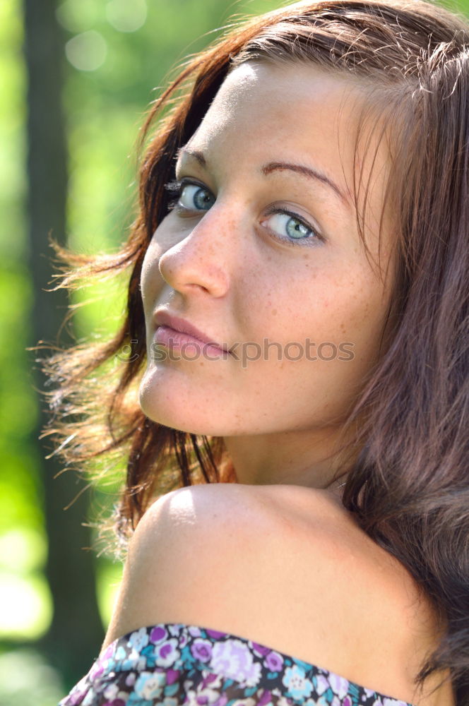 Similar – Young woman with freckles sits on a high flat roof in the evening light and smiles at the camera