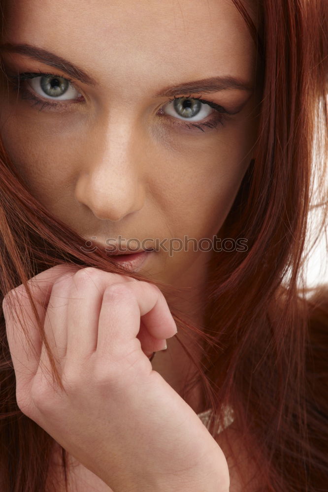 young woman with bright eyes, red hair and gap teeth smiles