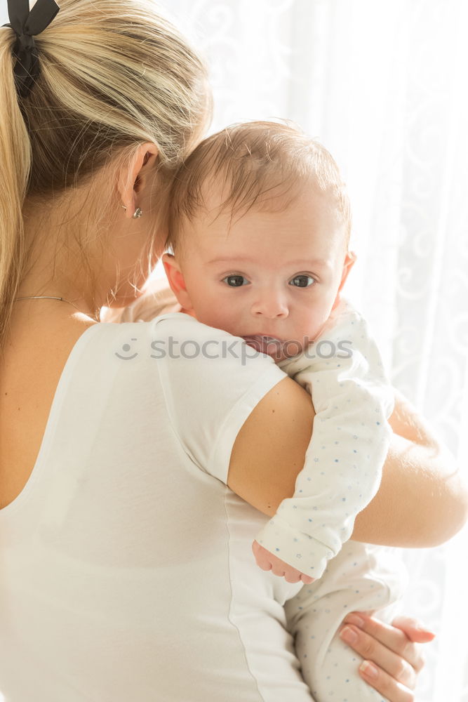 Similar – Woman playing with little happy baby on bed