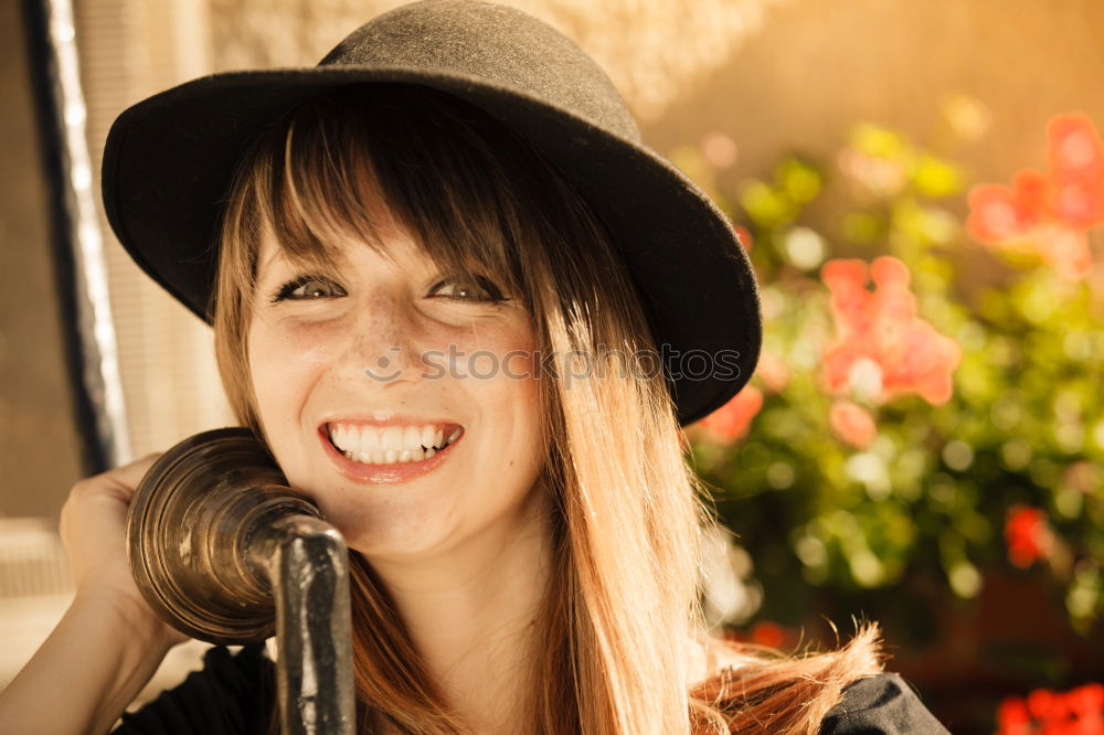 Woman with a hat for graffiti laughs with closed eyes