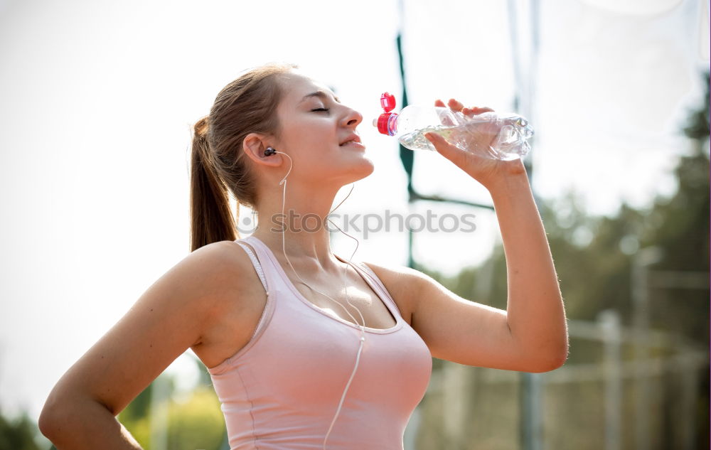 Fit sporty woman drinking water from a bottle