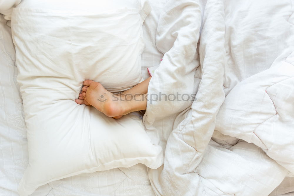 Similar – Image, Stock Photo A bed with two feet coming out of the sheets