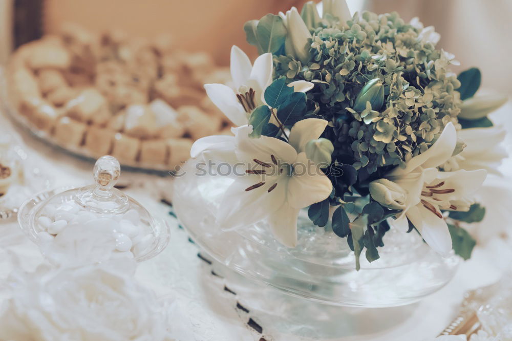 Similar – Low angle view of a pretty wedding bouquet of white flowers lying on a table top with selective focus and copyspace