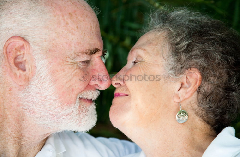 Similar – Smiling senior couple looks lovingly into each other’s eyes