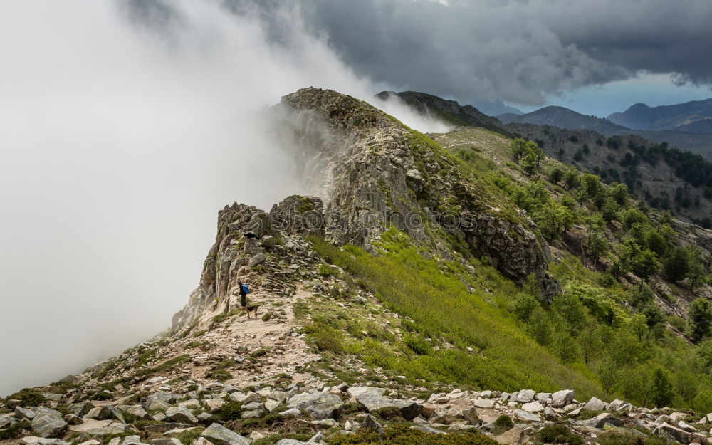 Hiker enjoys view in the fog in the Lechtaler Alps