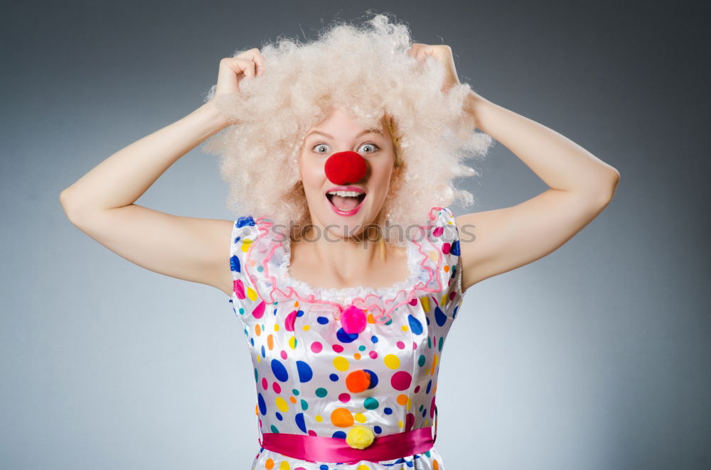 Similar – Young woman with pink hair is sticking out her tongue