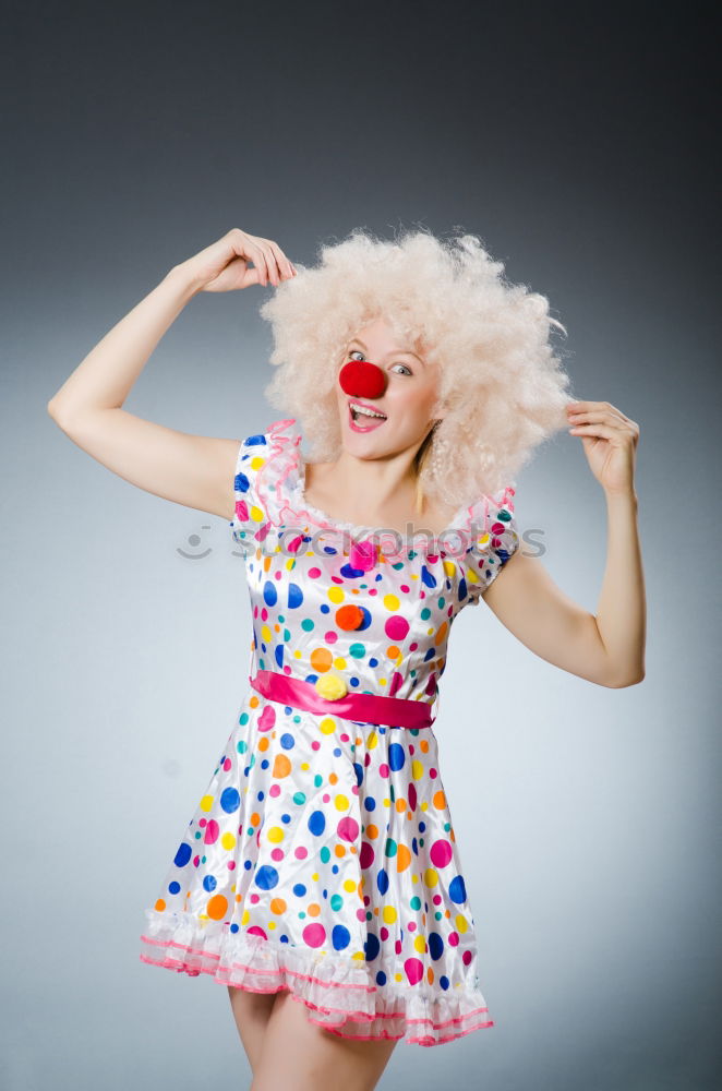 Similar – Young woman with pink hair is sticking out her tongue