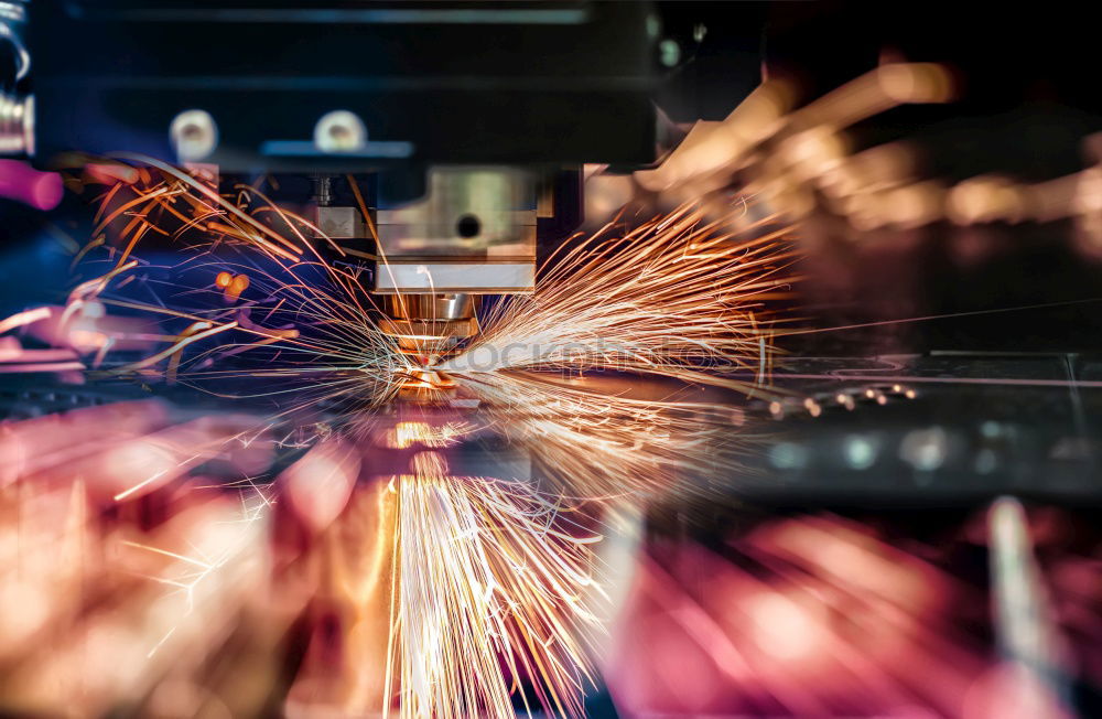 Similar – Mechanic man welding metal material in garage.