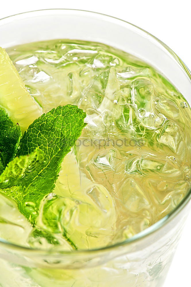 Mojito cocktail in glass on yellow background