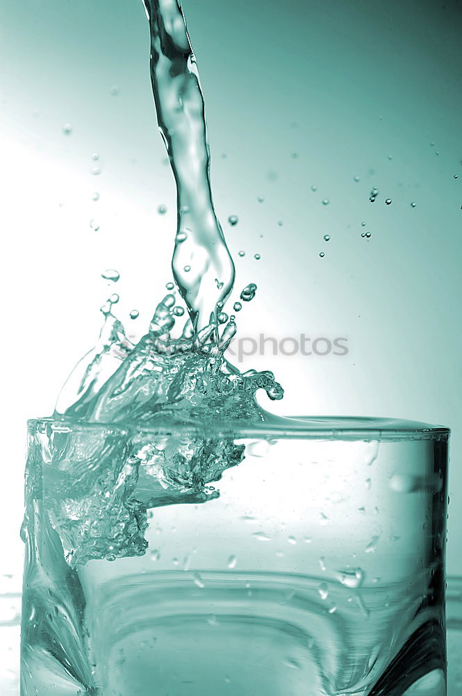 Similar – Half glass of water standing on the counter