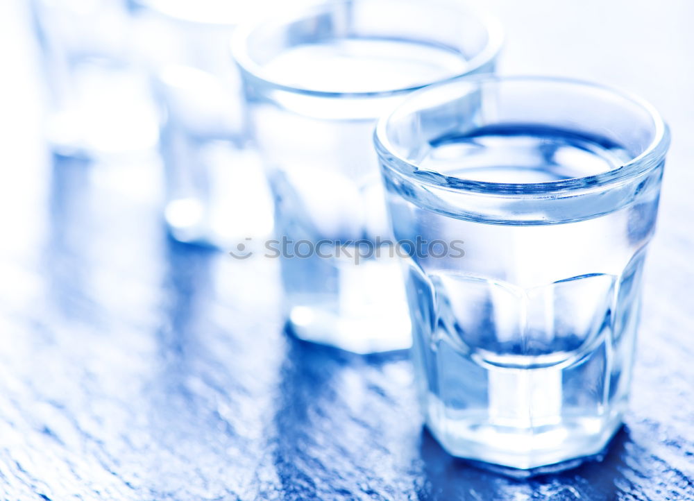 Similar – Glass filled to the brim with water in monochrome blue.