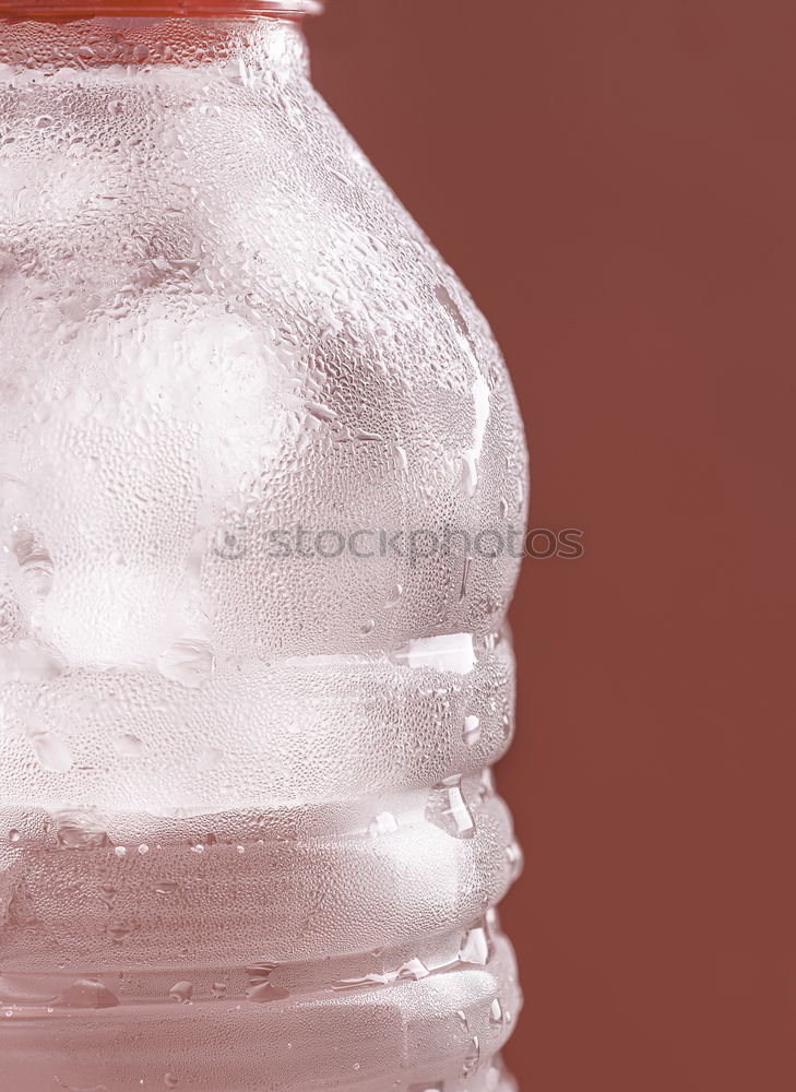 Water with ice in a plastic bottle. Frosted bottle close-up