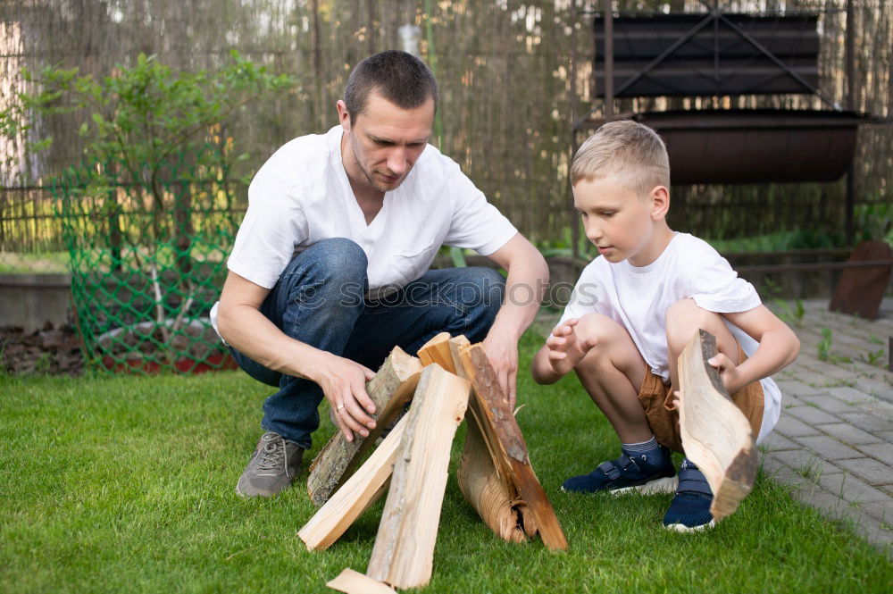 Image, Stock Photo Cheerful young man teaching his son to play mini golf