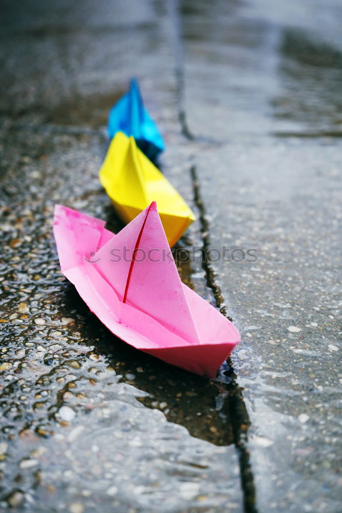 Color paper boats in a rainy day