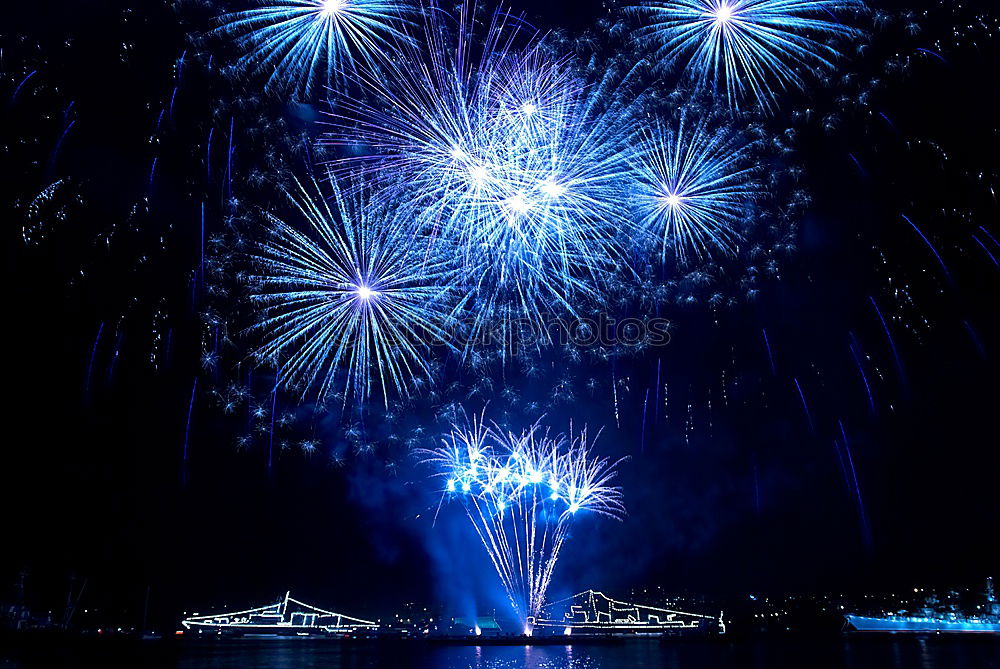 Similar – Blue colorful fireworks with water reflection