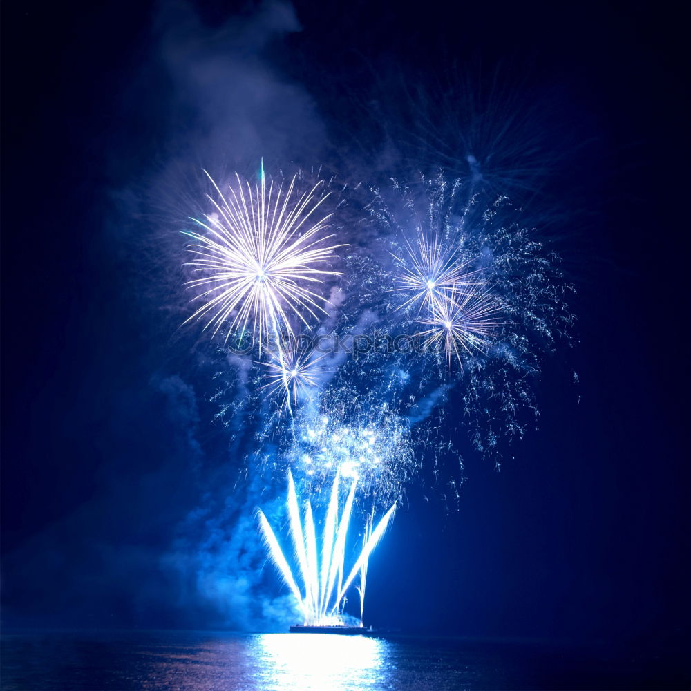 Similar – Blue colorful fireworks with water reflection