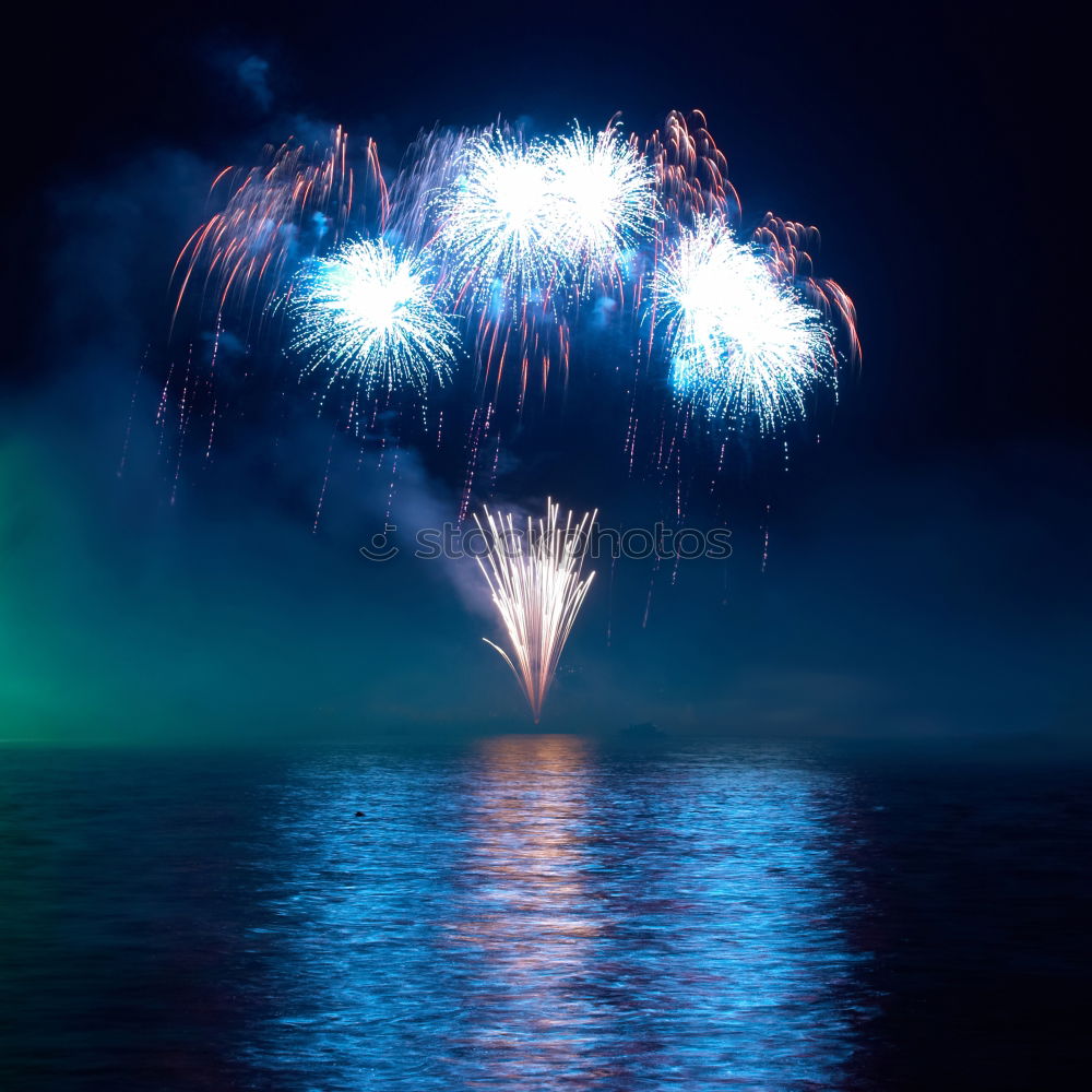 Similar – Colorful fireworks above a lake