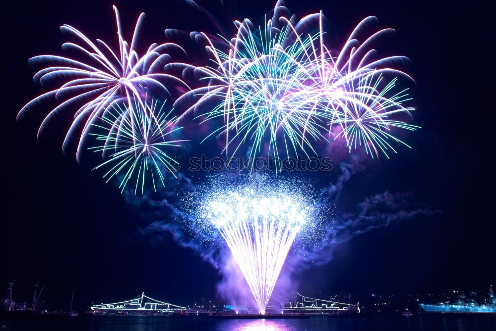 Similar – Colorful fireworks above a lake