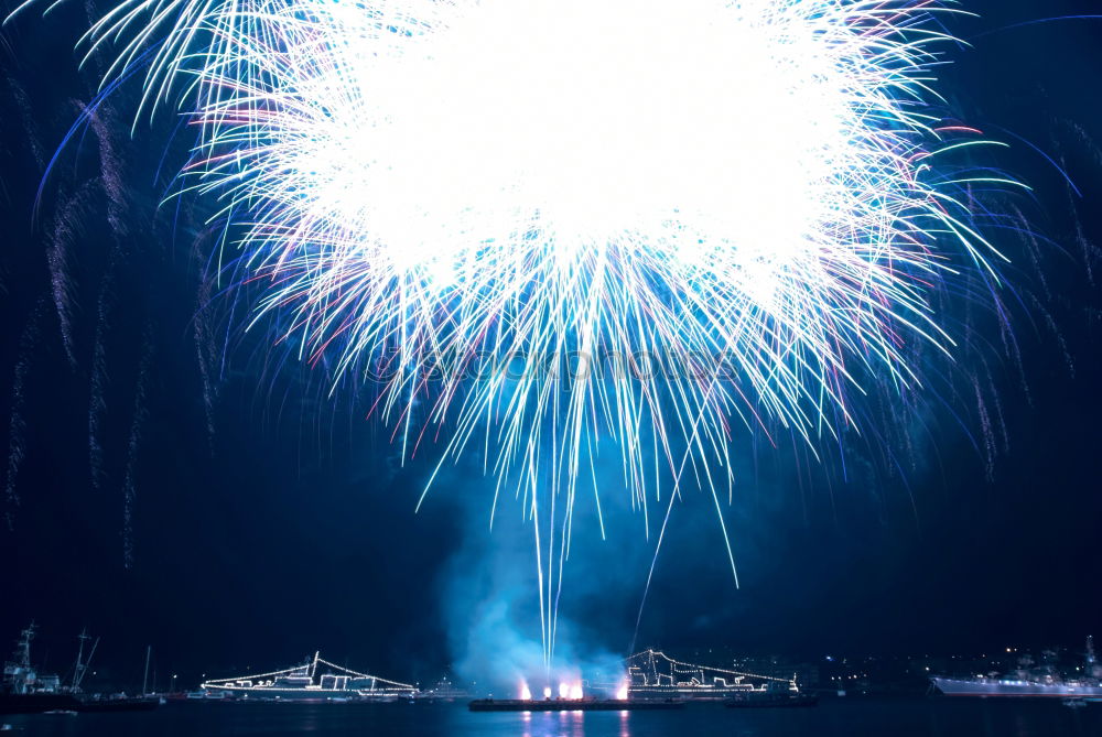 Similar – Blue colorful fireworks with water reflection