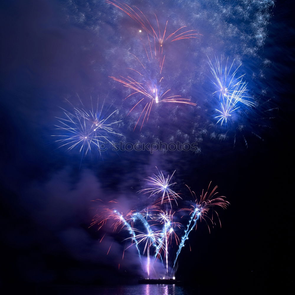 Similar – Colorful fireworks with water reflection