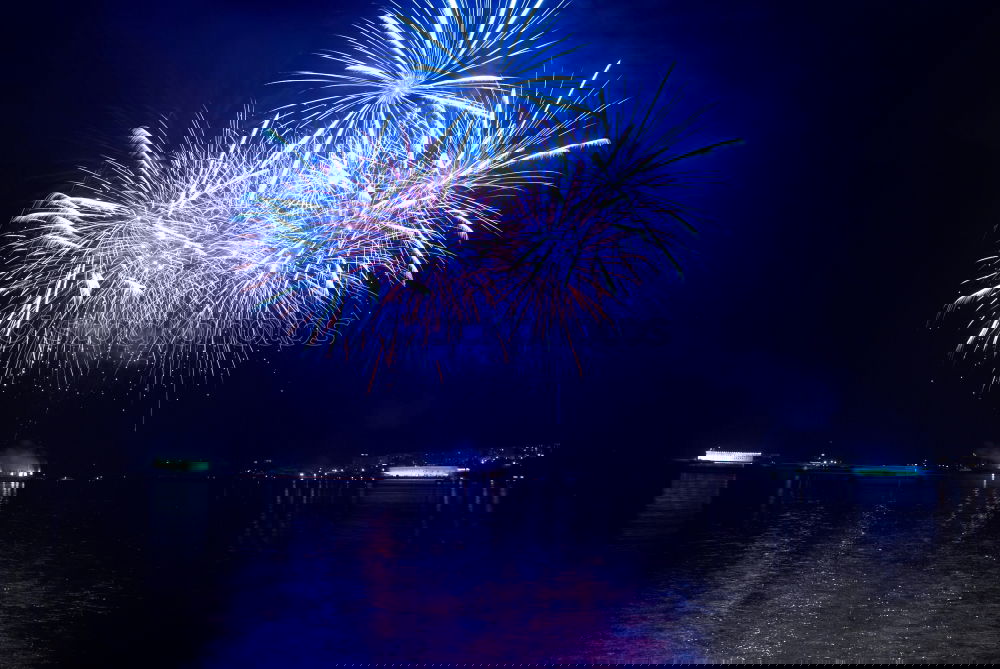 Similar – Image, Stock Photo Blue colorful fireworks on the black sky with water reflection