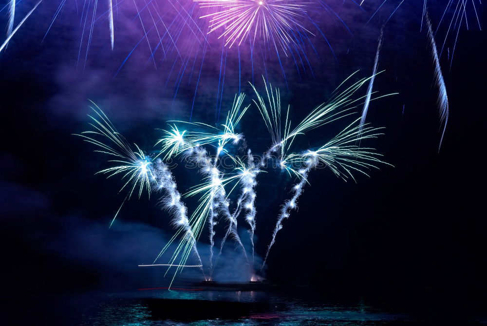 Similar – Blue colorful fireworks with water reflection