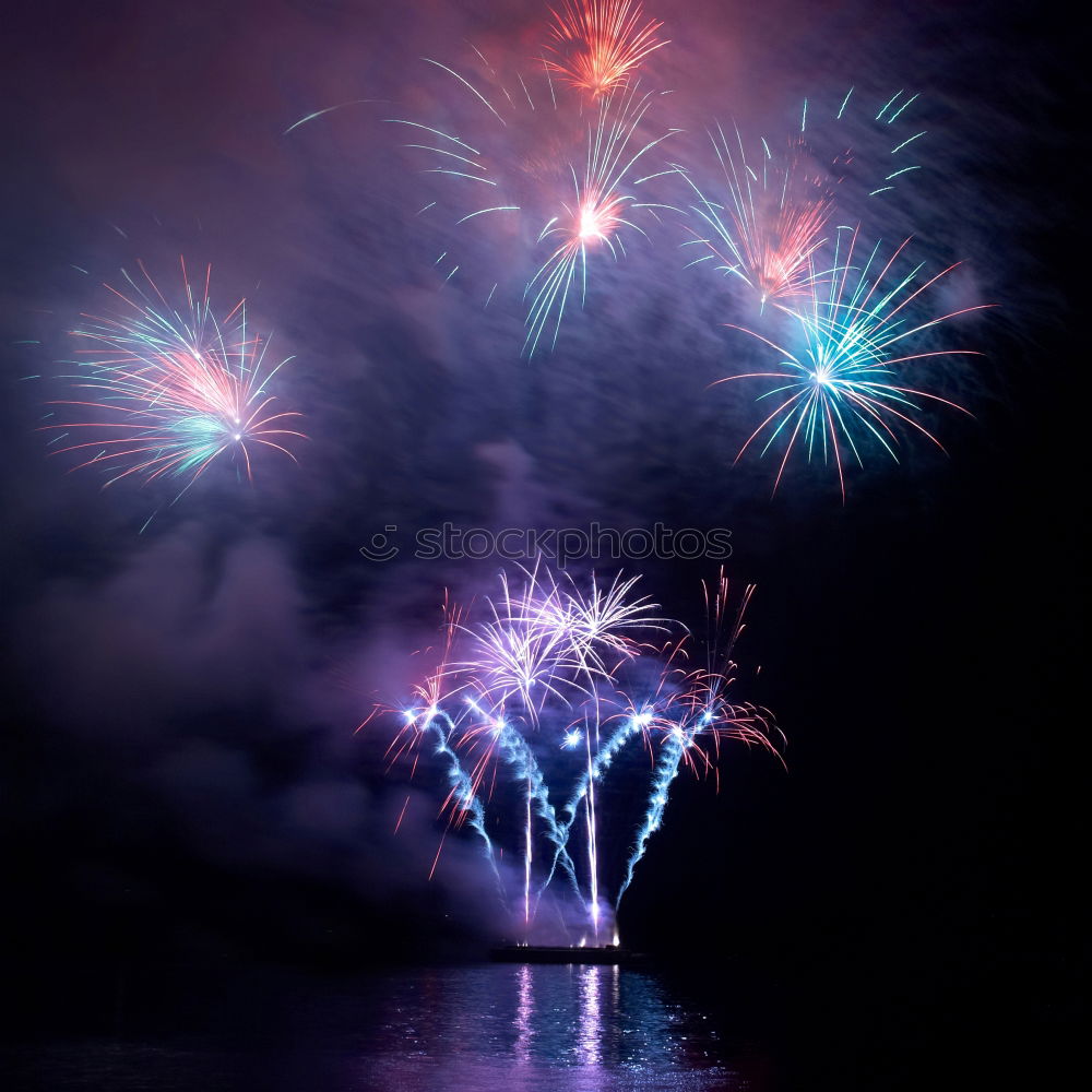 Similar – Colorful fireworks with water reflection