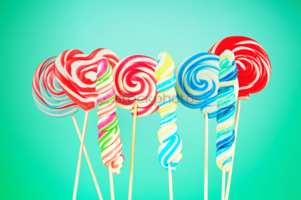 Similar – Image, Stock Photo Colorful lollipops on blue background. Top view.