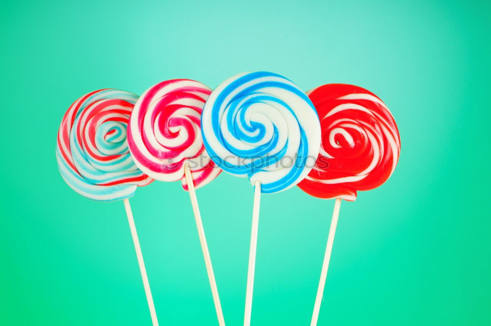 Similar – Image, Stock Photo Colorful lollipops on blue background. Top view.