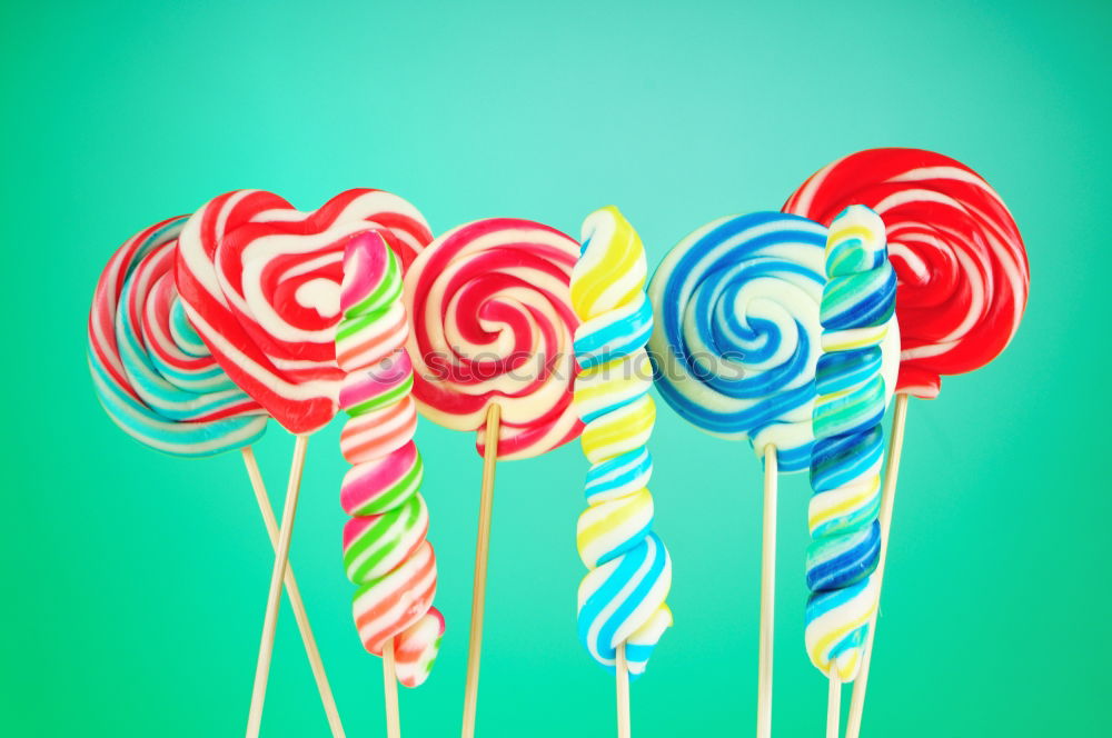 Similar – Image, Stock Photo Nice lollipop with many colors in a spiral on a blue background