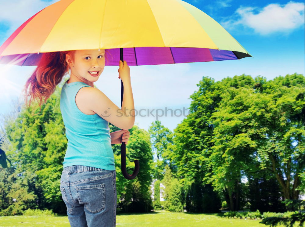 Similar – happy kid girl hiding under umbrella