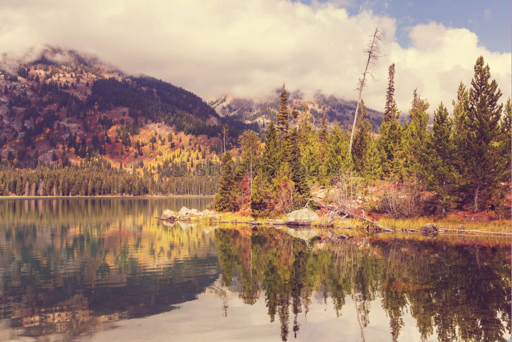 Similar – Wonderful lake between hills in snow and cloudy sky